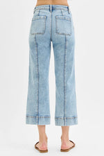 Light blue jeans worn by a person on a white background