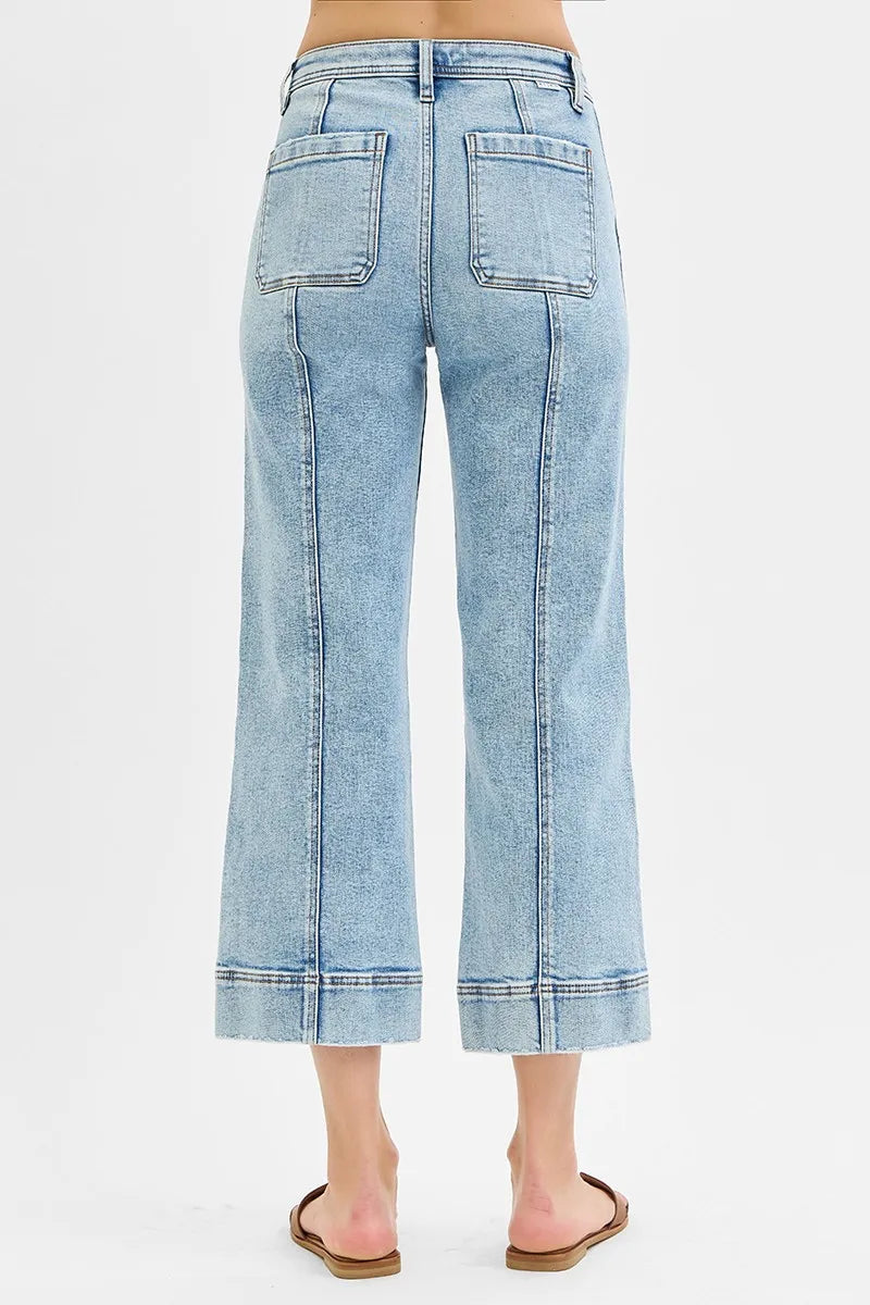 Light blue jeans worn by a person on a white background