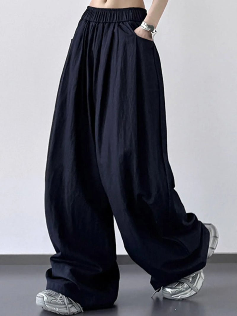 Black wide-leg pants worn by a person on a plain background