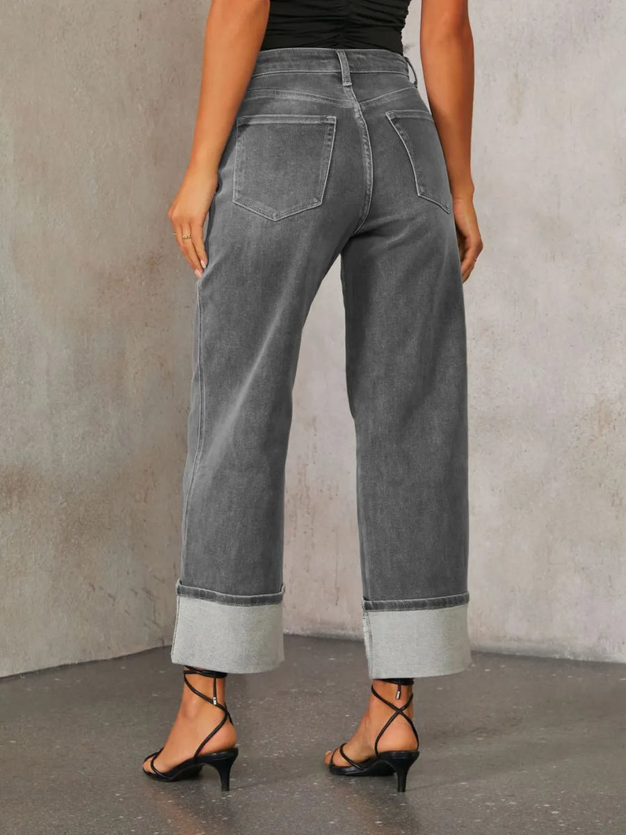 Person wearing gray wide-leg jeans against a plain background