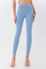 Light blue leggings worn by a person on a white background