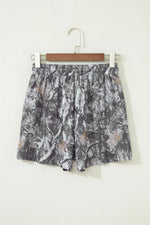 Floral patterned skirt on a hanger against a white background