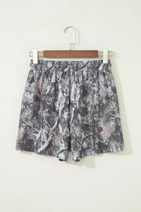 Floral patterned skirt on a hanger against a white background