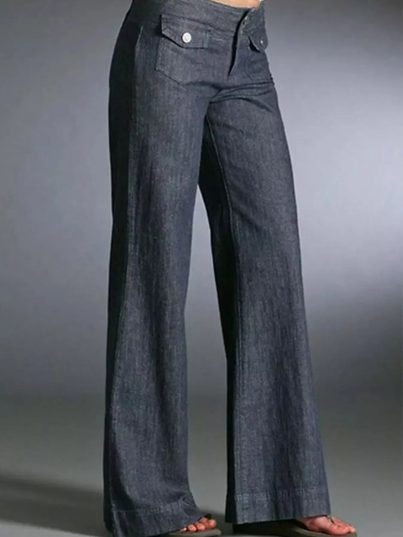 Dark blue wide-leg jeans on a gray background