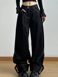 Black wide-leg jeans worn by a person on a plain background
