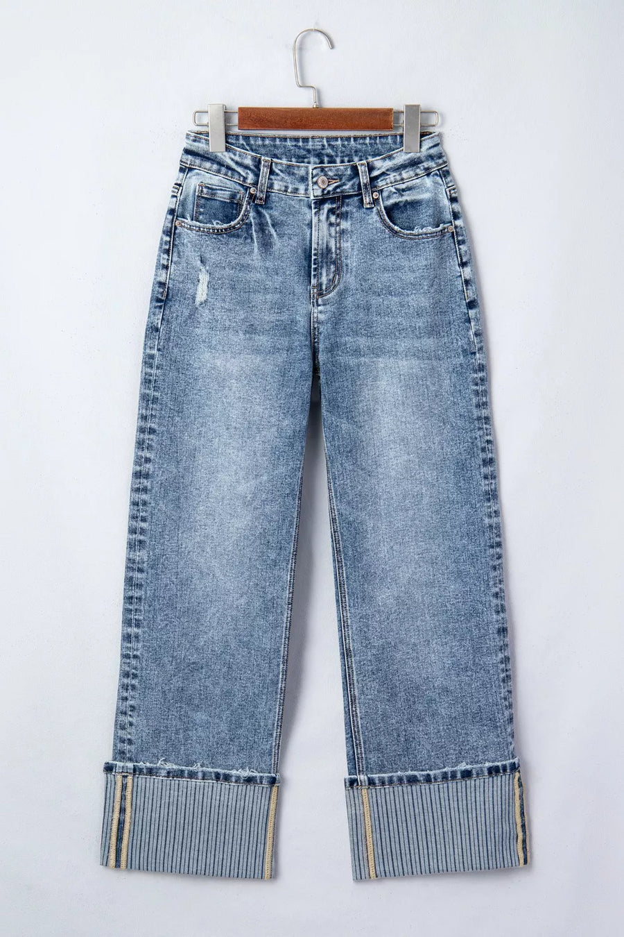 Light blue jeans with rolled-up cuffs on a white background