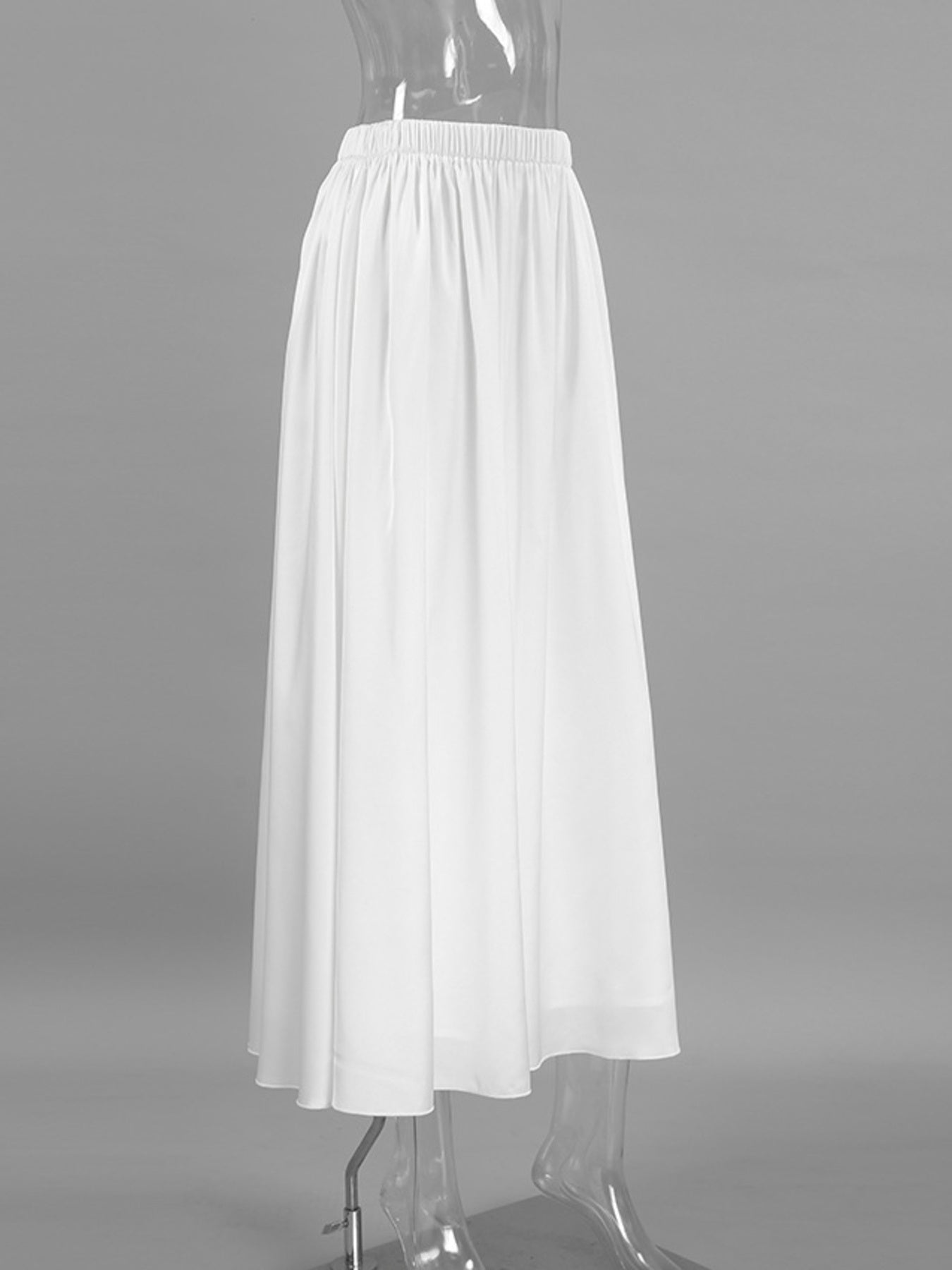 White skirt on a mannequin against a gray background