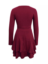 Maroon dress with long sleeves and a layered skirt on a white background