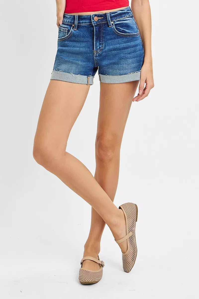 Person wearing blue denim shorts on a white background