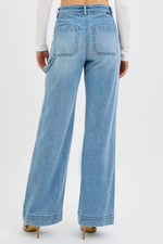 Light blue wide-leg jeans worn by a person on a white background