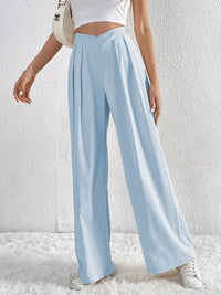Light blue wide-leg pants worn by a person on a white background