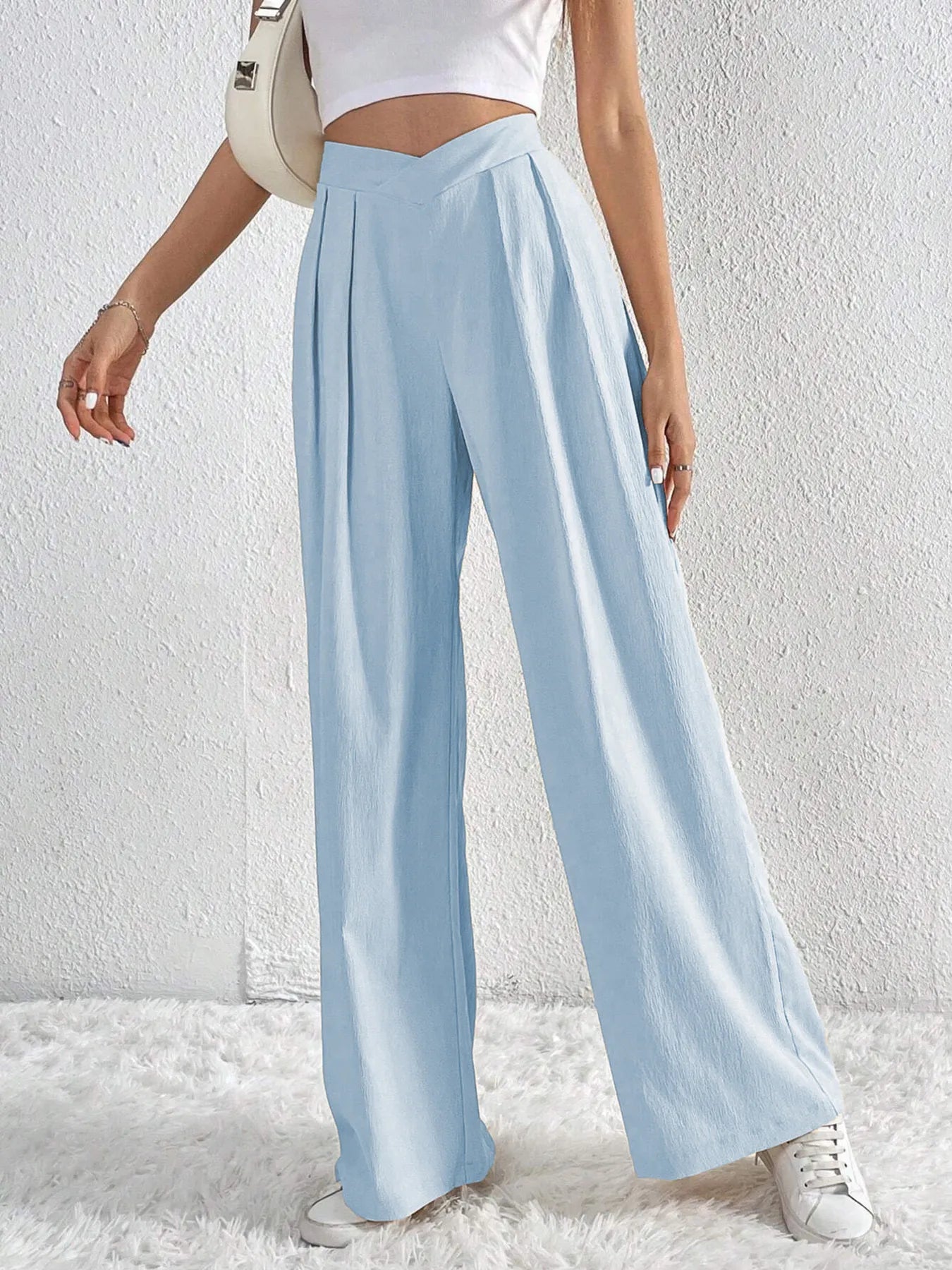 Light blue wide-leg pants worn by a person on a white background