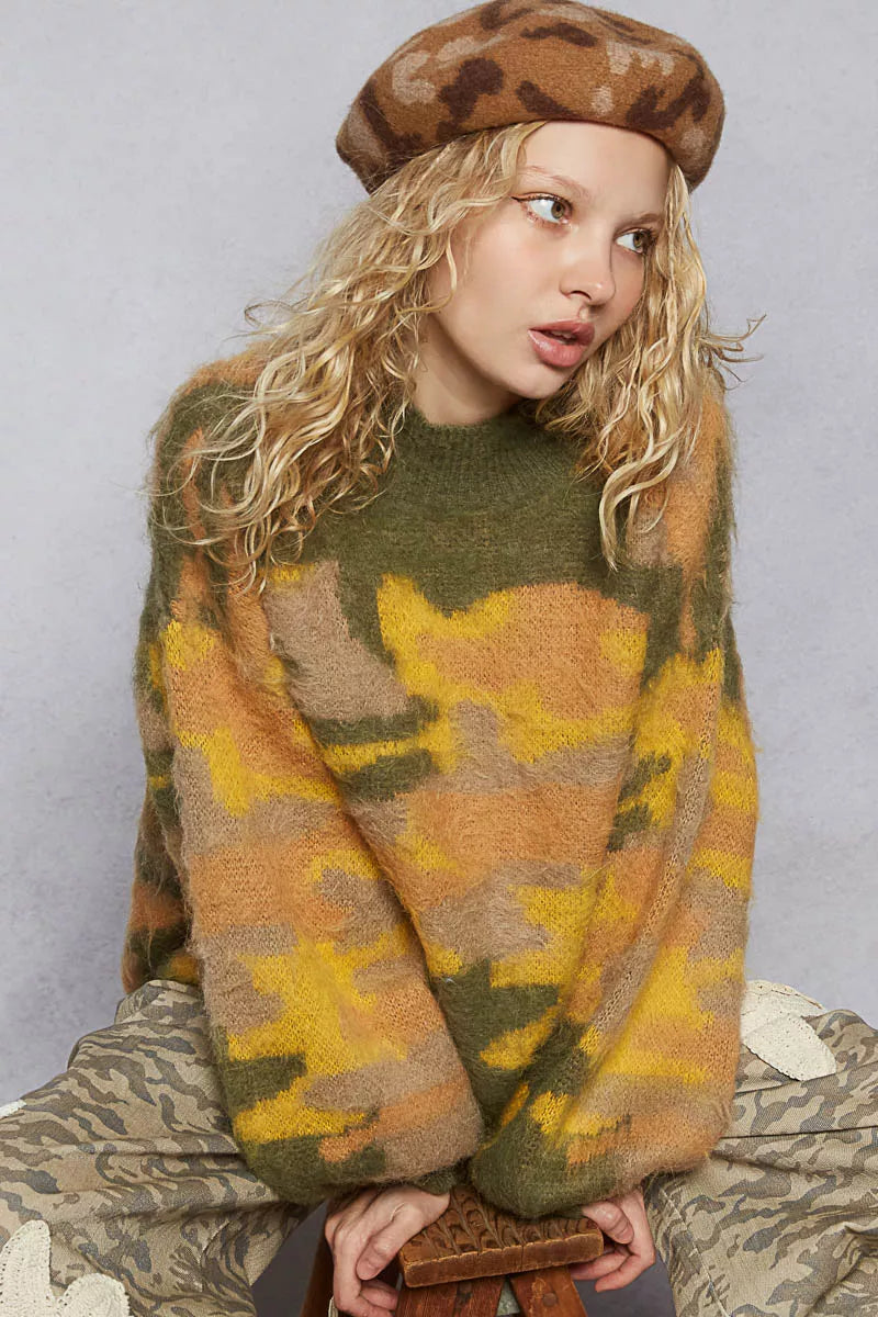 Woman wearing a patterned sweater and beret against a plain background