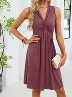 Woman wearing a maroon dress with a white background
