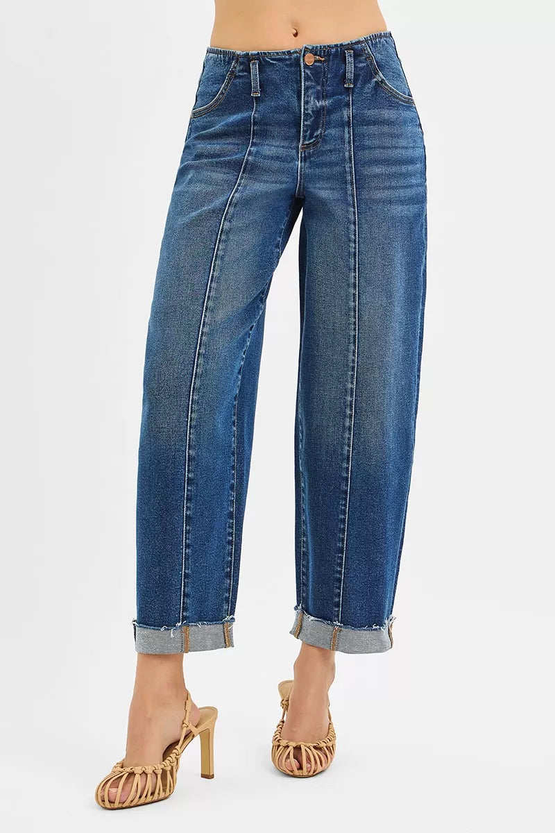 Blue jeans worn by a person on a white background