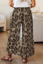 Person wearing leopard print pants in a living room setting