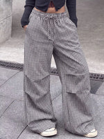 Model showing both pockets on High-Waisted Gingham Wide-Leg Drawstring Pants For Women