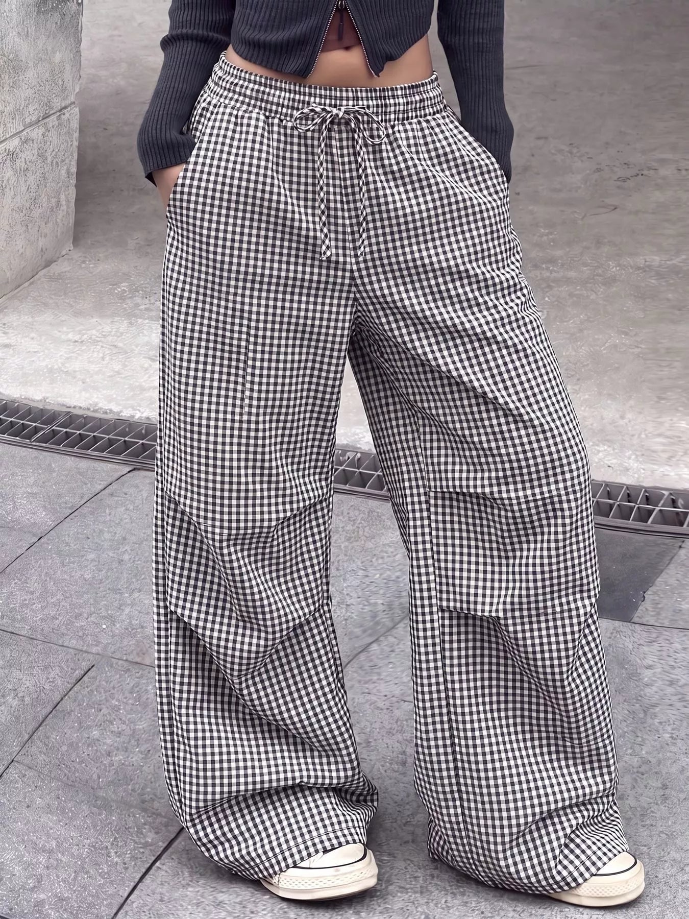Model showing both pockets on High-Waisted Gingham Wide-Leg Drawstring Pants For Women