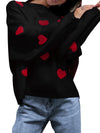 Black sweater with red heart patterns worn by a person, on a white background