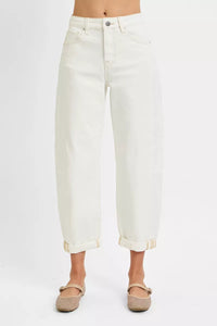 White jeans worn by a person on a white background
