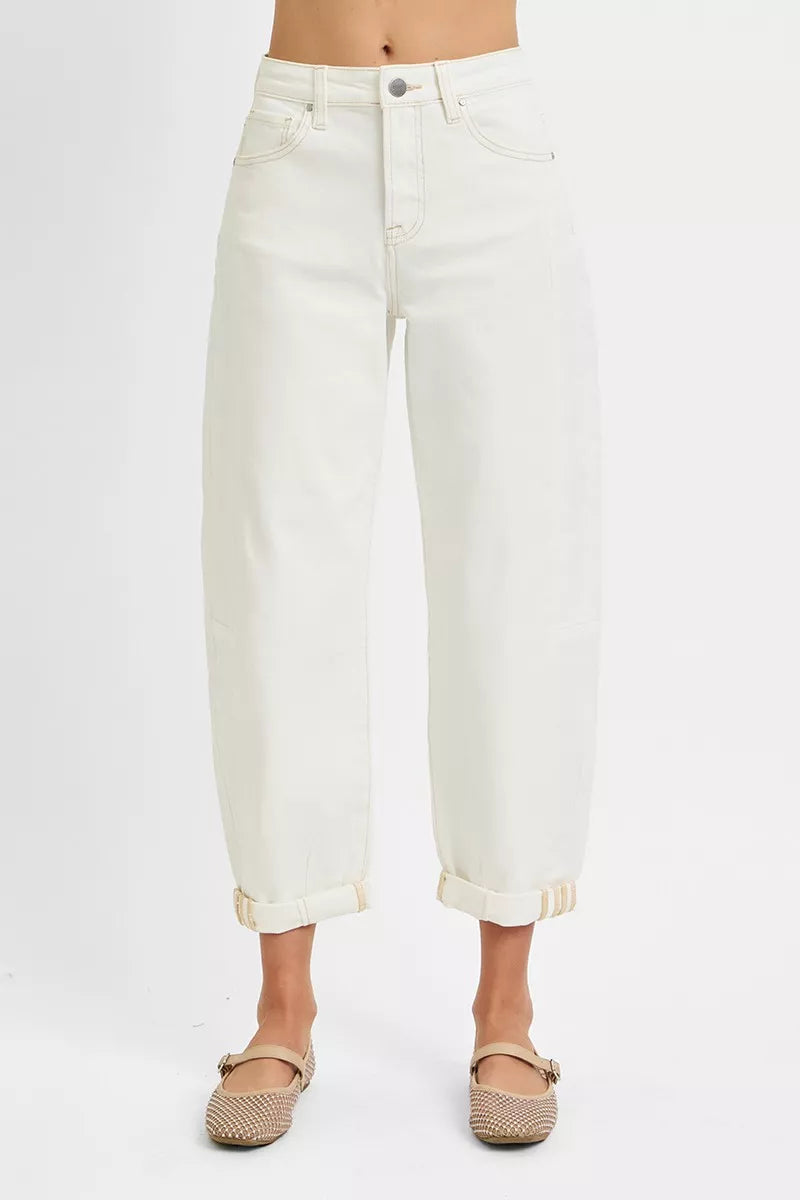 White jeans worn by a person on a white background