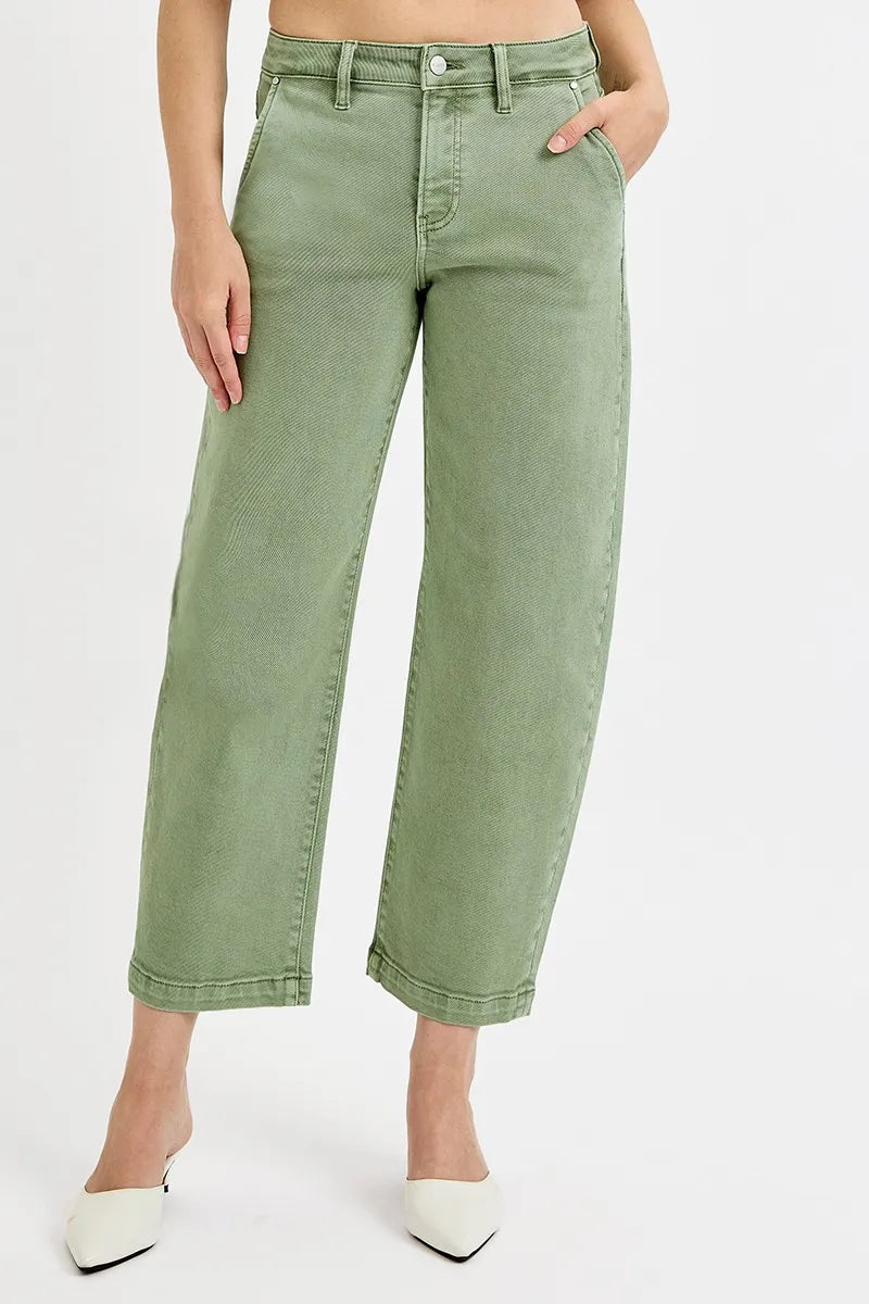 Person wearing green wide-leg jeans on a white background