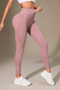 Pink leggings worn by a person on a beige background