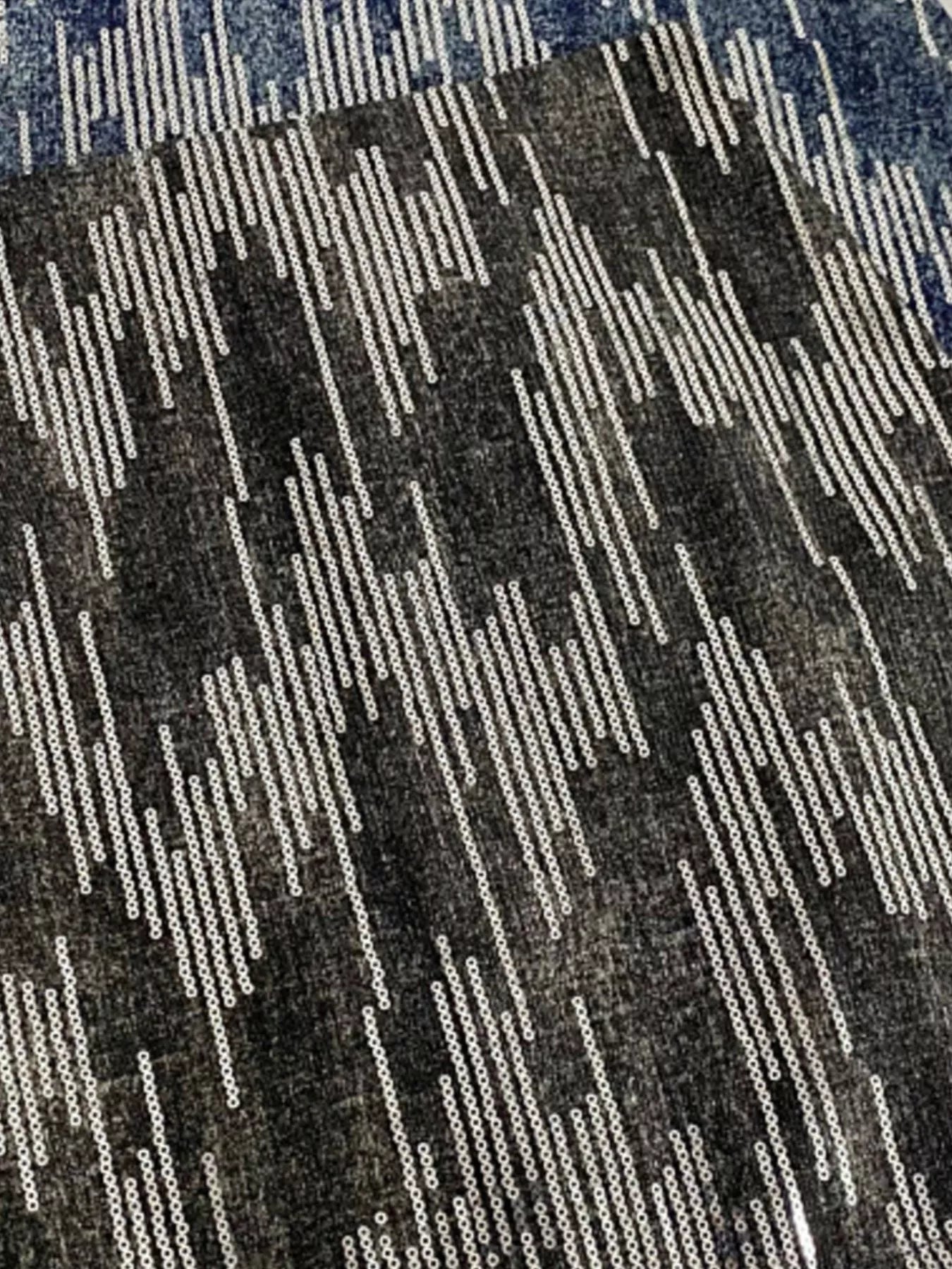 Patterned fabric with a geometric design in black, white, and blue.
