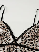 Leopard print bra with black lace trim on a white background