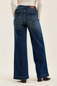 Blue jeans worn by a person on a white background