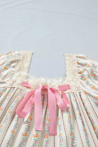 Floral dress with pink ribbons on a light blue background