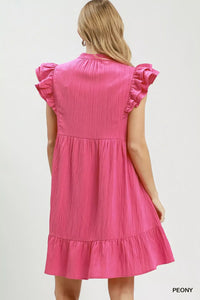 Pink dress with ruffled sleeves on a white background