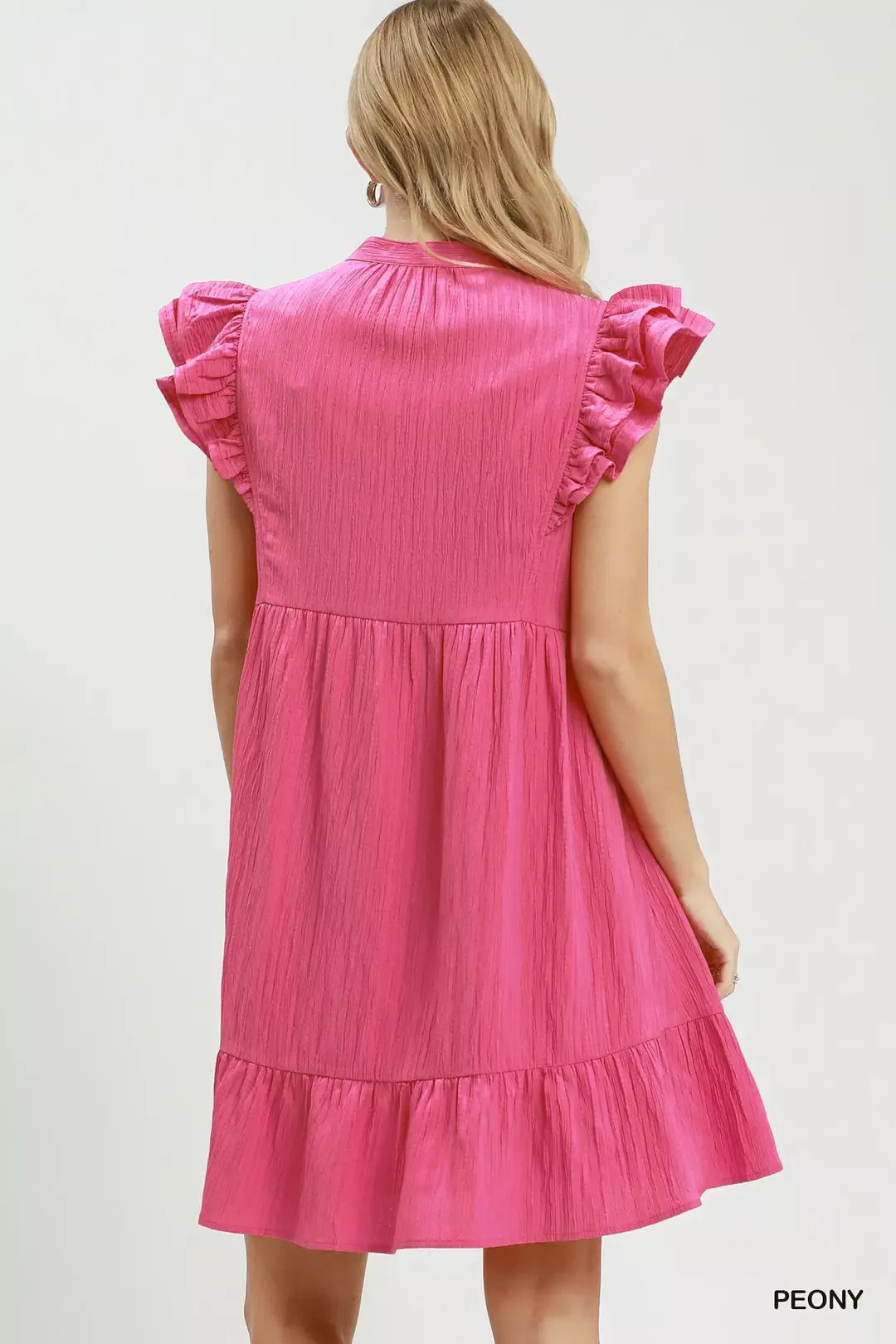 Pink dress with ruffled sleeves on a white background