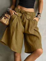 A woman posing in a green High-Waisted Drawstring Shorts 