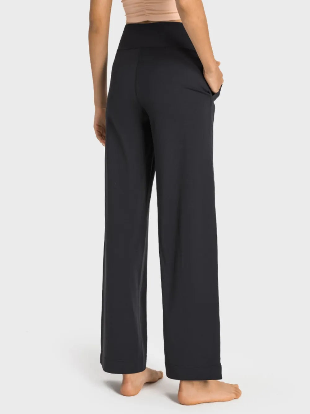 Person wearing black pants on a white background