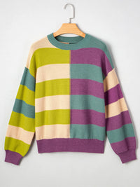 Colorful striped sweater on a hanger against a white background
