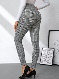 Person wearing plaid pants with a white background