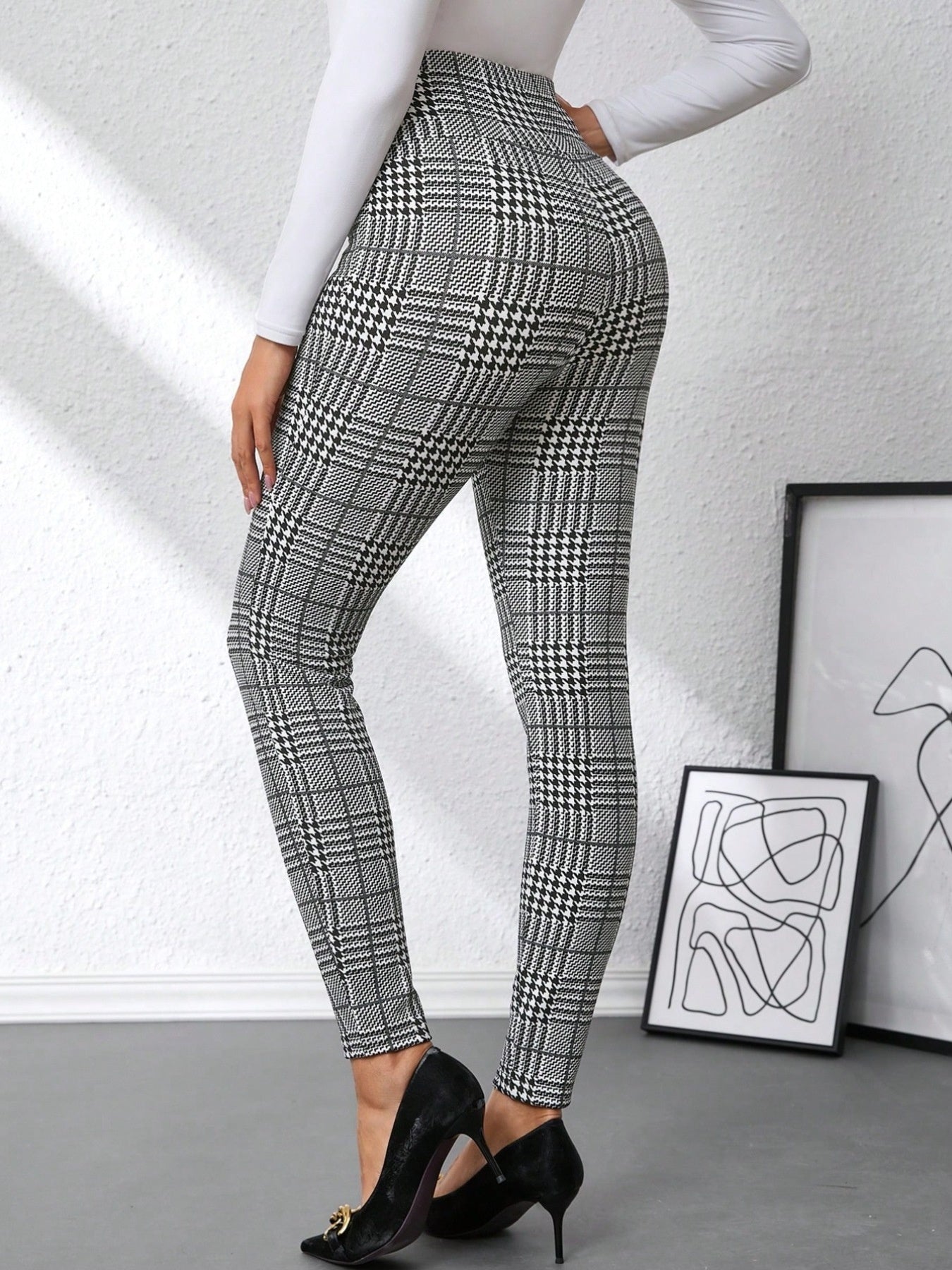 Person wearing plaid pants with a white background