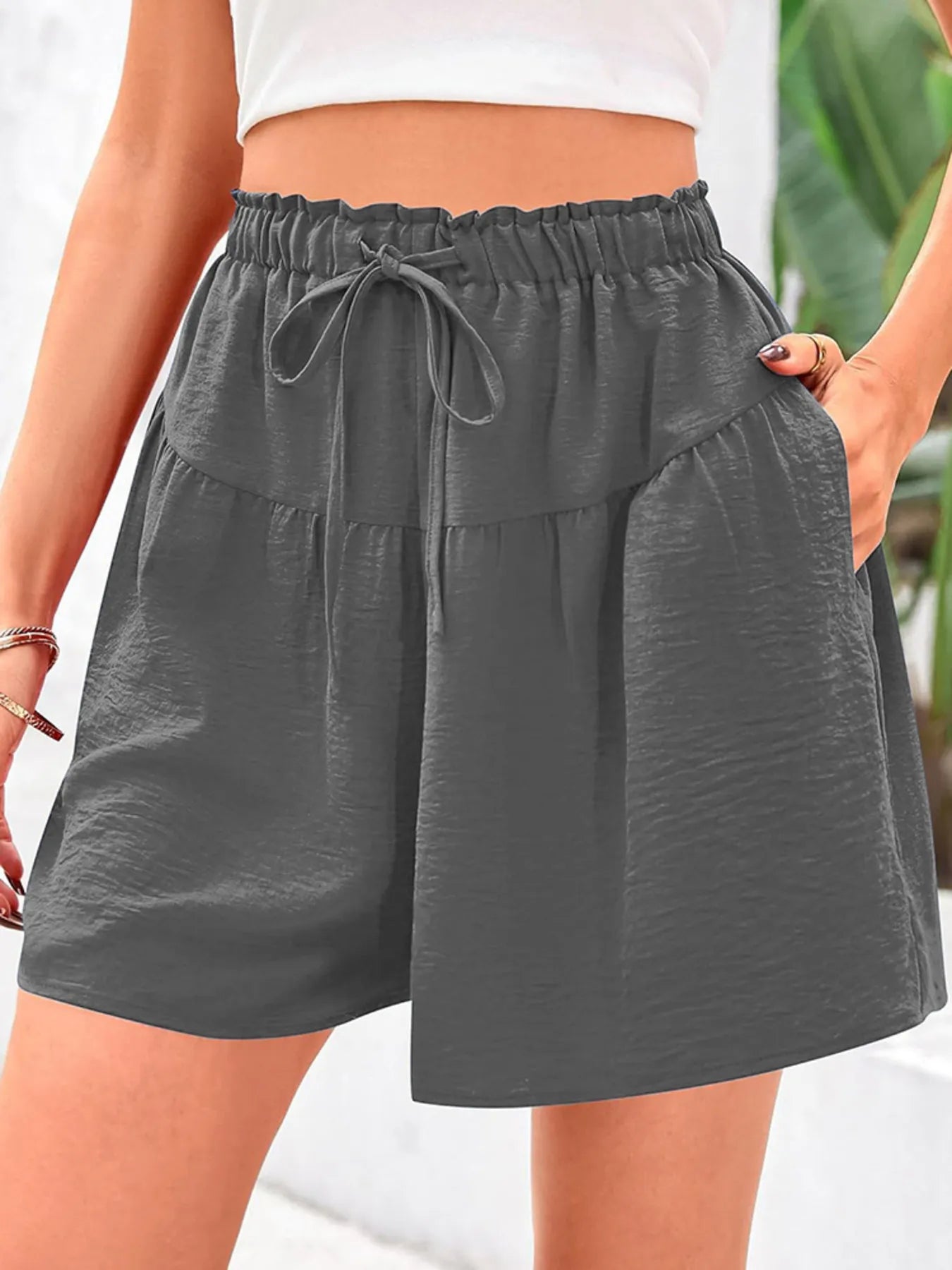 Gray shorts with a drawstring waist on a blurred background