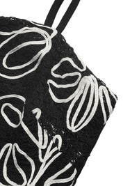 Black pouch with white floral patterns on a white background