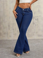 Person wearing blue flared jeans against a neutral background