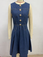 Blue denim dress on a mannequin against a white background
