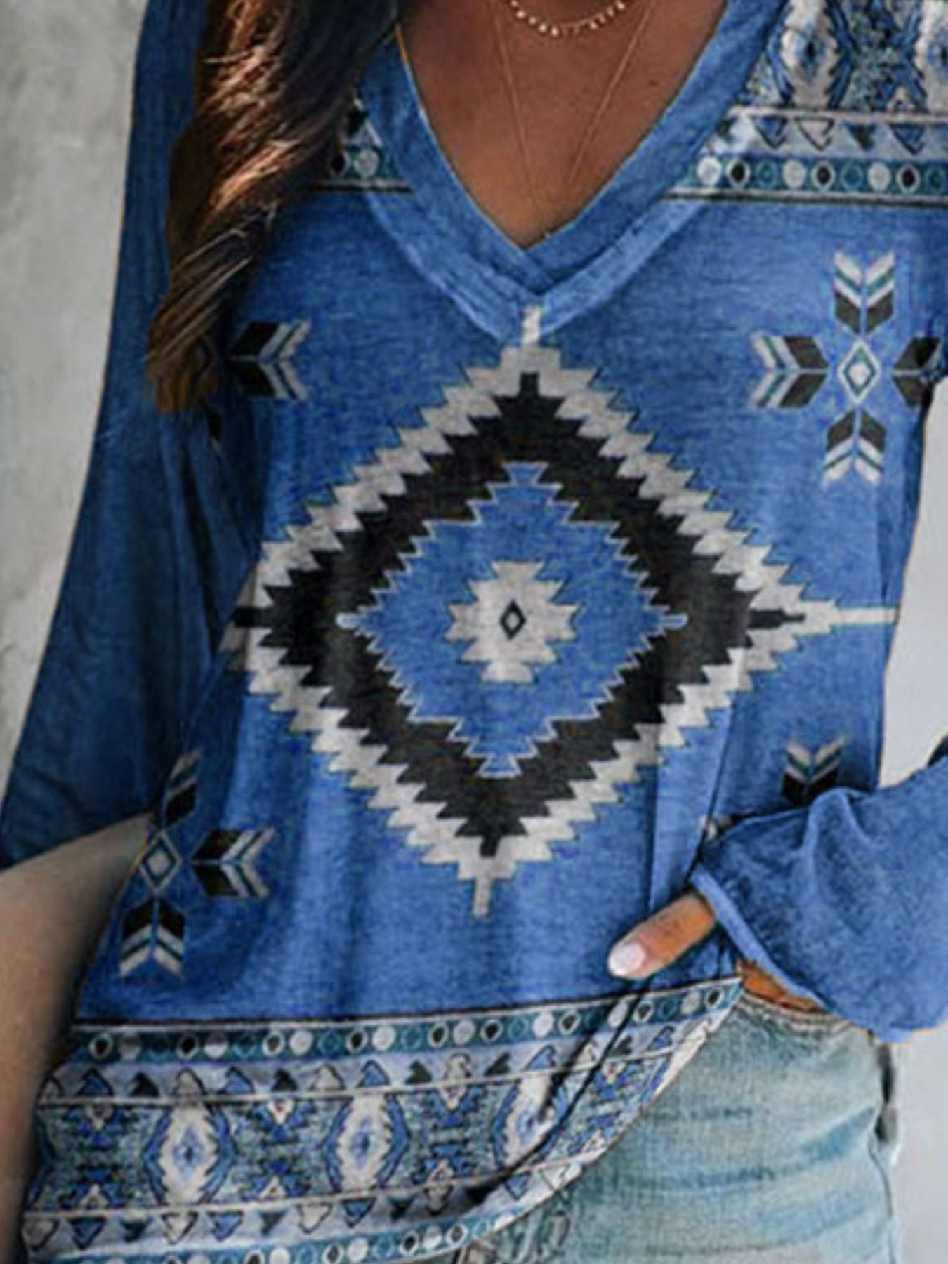Blue patterned top worn by a person, with a focus on the design.