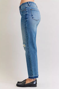 Light blue jeans worn by a person on a plain background