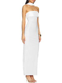 Woman wearing a strapless white evening gown on a white background