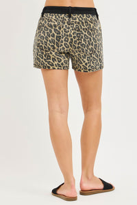 Leopard print shorts worn by a person on a plain background
