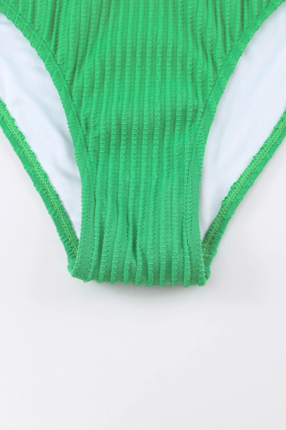 Green ribbed swimsuit bottom on a white background