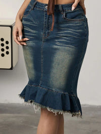 Blue denim skirt with ruffled hem on a neutral background