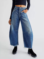 Person wearing blue wide-leg jeans on a white background