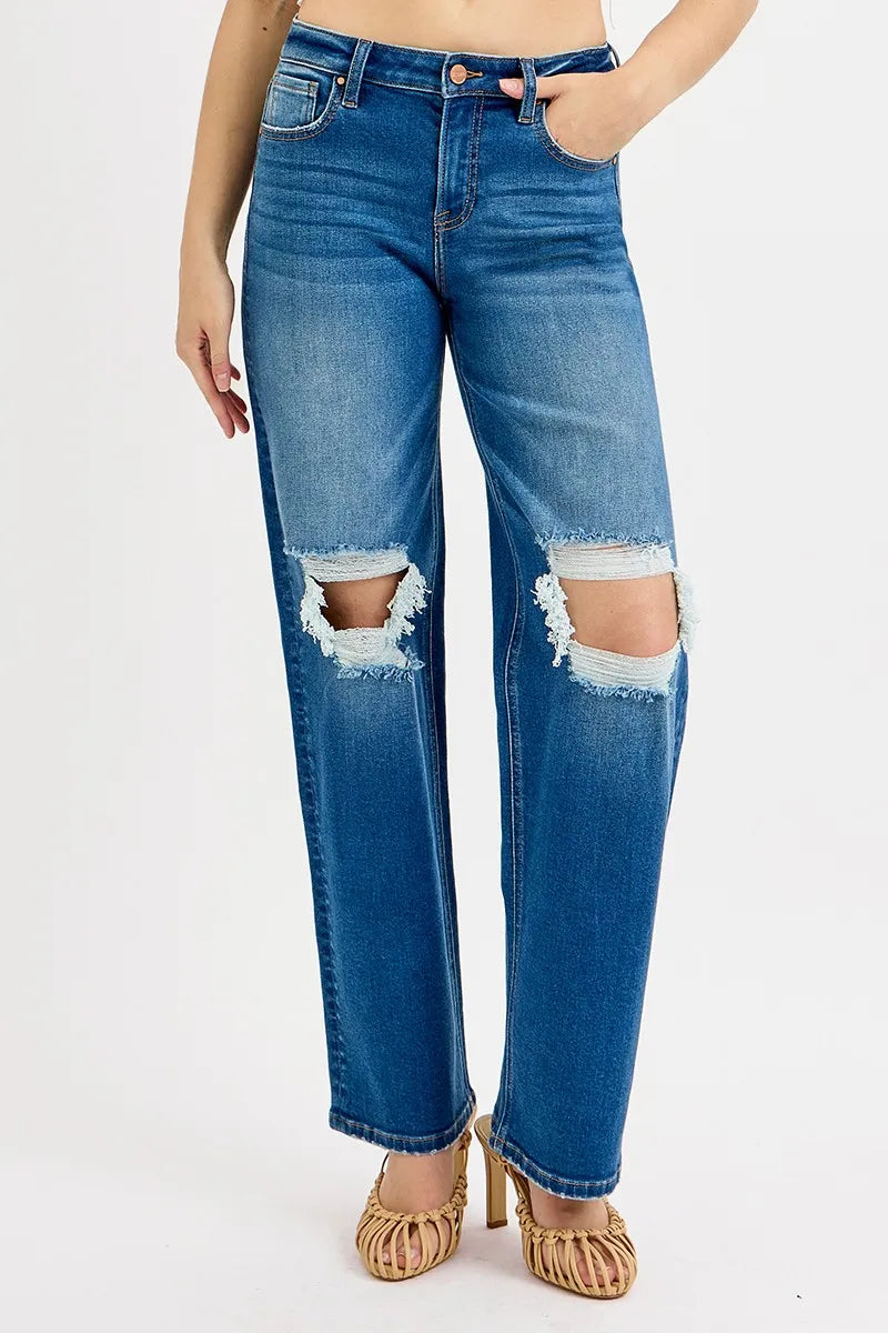 Blue jeans with distressing on a white background